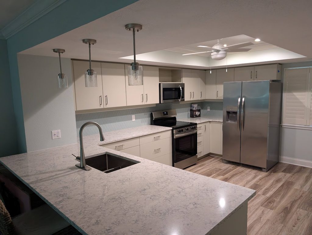 Single-tier peninsula with new backsplash and repainted cabinets