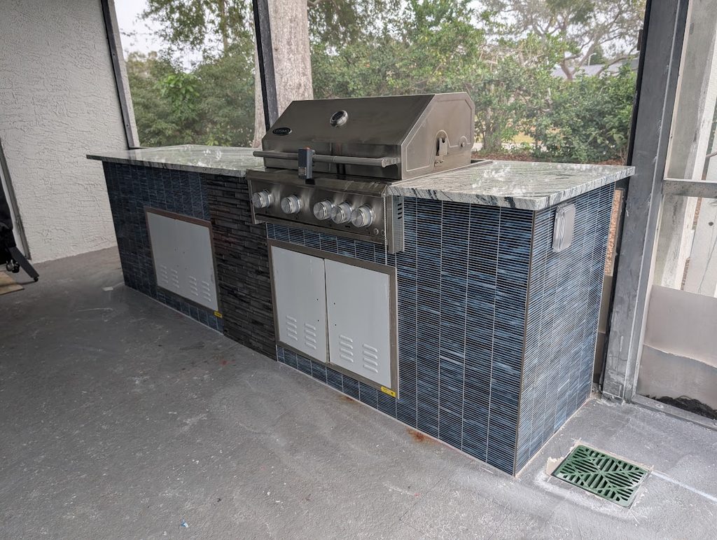 Tiled island with stainless doors and integrated lighting