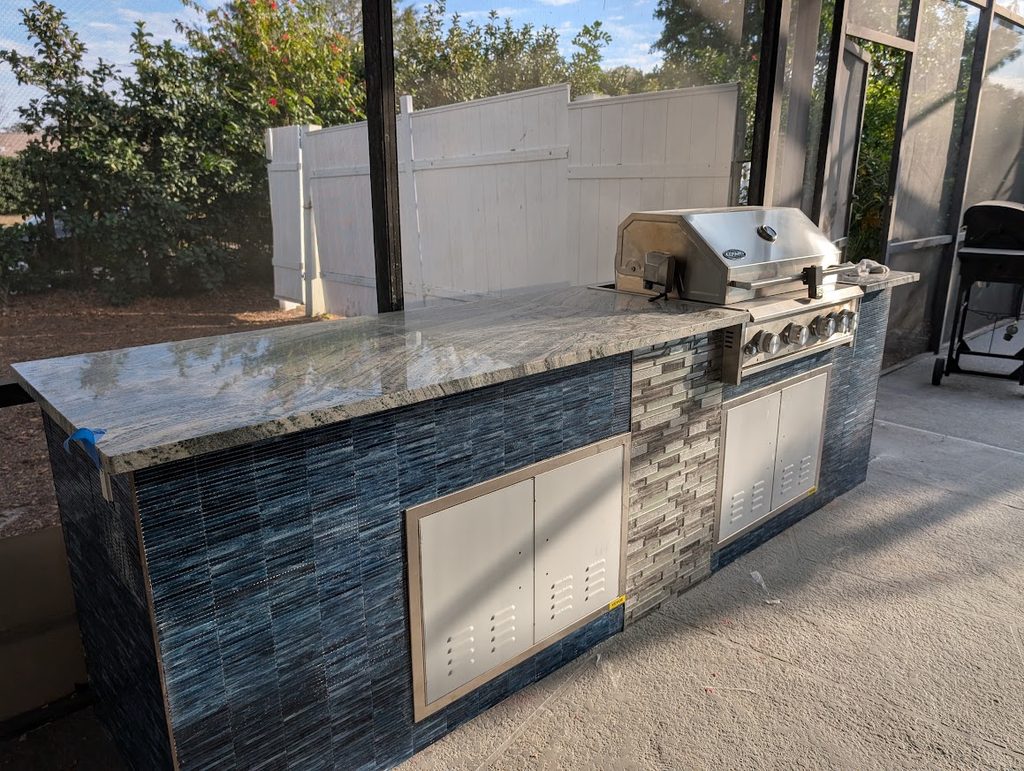 Tiled island with stainless doors and integrated lighting