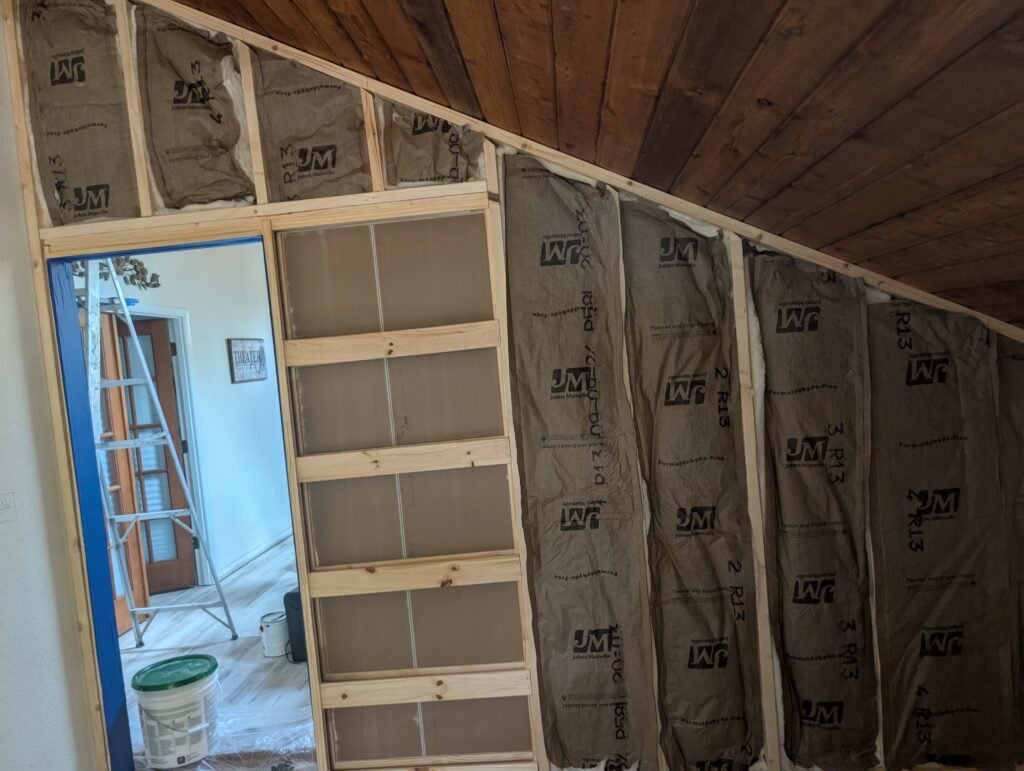 Completed bedroom with tile accent fireplace and custom closet