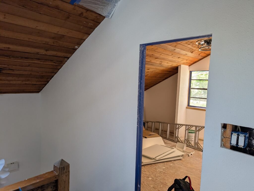 Completed bedroom with tile accent fireplace and custom closet